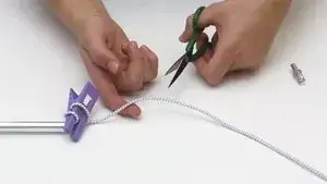 Now attach the end pin to this side of the shock cord, tie a knot in it, and insert it into the pole.