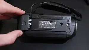 Pull the battery up and outwards to "unhook" it from the camera body.
