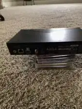 Remove the outer three black screws on the back of the device. Do not remove the silver screw above the HDMI port yet. Do not remove the black screw next to the COAX jack yet.