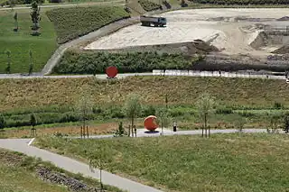 Территория впереди может быть отмечена на карте leisure=park + abandoned:landuse=landfill или abandoned:landuse=quarry.