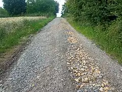 Poorly made surface=compacted eroded by water, turned into surface=gravel