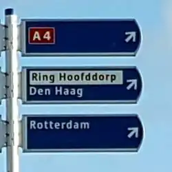The older/traditional signposting style for ring routes renders Ring Hoofddorp as a local destination, separately from any road number (here A 4). Add name=Ring Hoofddorp and noref=yes to the ring route relation.
