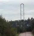 A high voltage line tower with a staple shape structure.