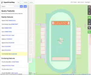 Screen shot of a sports field with an American football end-zone tagged as landuse=commercial to get a pink fill and each letter tagged as natural=sand to get a yellow fill.