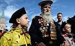 Georgy Shirokov, 91-year-old Russian veteran of World War II and former sailor of the Baltic Fleet walks with his great grandchildren
