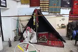An old man in a tent