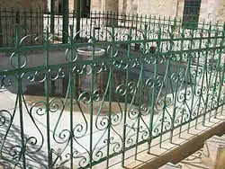 Closeup of the pool, enclosed by green banisters (handrails)