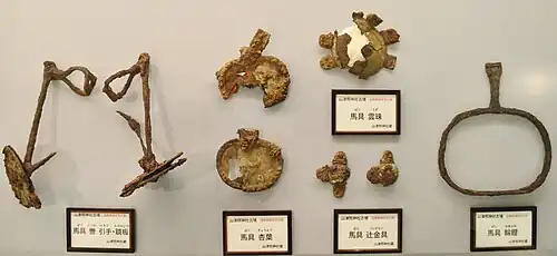Kutsuwa bit and kagami-ita cheekpieces, gyōyō and uzu decorations, and wa-abumi ring stirrup, from Yamatsuteru Jinja Kofun&nbsp;[ja], Shiga Prefecture (Shiga Prefectural Azuchi Castle Archaeological Museum&nbsp;[ja])