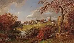 View of village and church steeple seen through the trees during autumn, the leaves have changed to fall colors