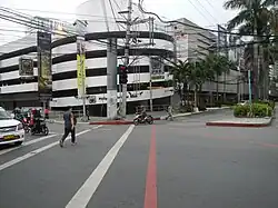 An intersection with a crossing pedestrian.