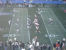 Two football teams on the field in position prior to the play