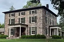 Historic stone house overlooking the river