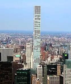 432 Park Avenue and surrounding buildings as seen from the Empire State Building on a sunny day.