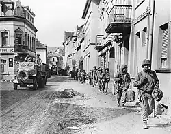 American Soldiers march through a German town in 1945