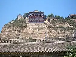 Nanhua Amituo Fo Temple of Chinese Buddhism seen on a hill above the roofs of the Yu Baba Gongbei, a Sufi shrine.