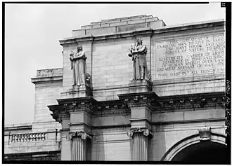 Detail of the west end of the main entrance pavilion, showing statuary and inscription