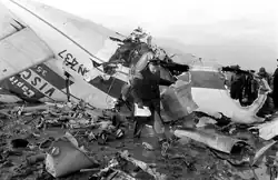 A first responder removes debris from the wreckage of Capital Airlines Flight 67.