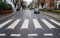 Abbey Road crosswalk in London, where the band "The Beatles" took a famous photo while they crossed it