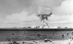 The airburst nuclear explosion of July 1, 1946. Photo taken from a tower on Bikini Island, 3.5 miles (5.6&nbsp;km) away.