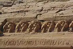 Baboon carvings above the heads of the statues of Ramses at the Great Temple
