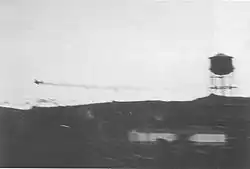 The Zero trailing oil over Dutch Harbor, moments after being hit