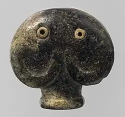 Amulet in the form of a head of an elephant; 3500–3300&nbsp;BC; serpentine (the green part) and bone (the eyes); 3.5 × 3.6 × 2.1&nbsp;cm; Metropolitan Museum of Art (New York City)