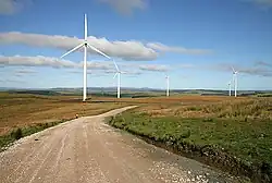 The towers of wind turbines support the rotors.