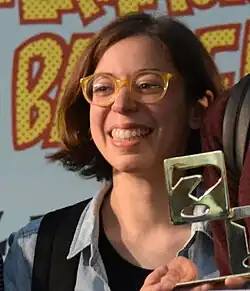Smiling young woman wearing glasses.