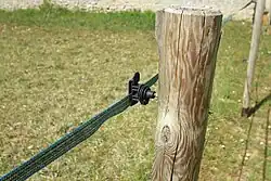 Positive punishment: a horse that touches this fencing tape will receive a mild electric shock, dissuading it from doing it again.