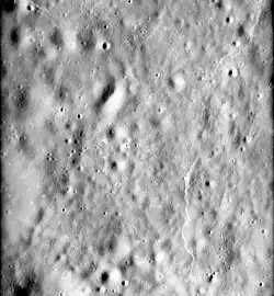 The floor of Mandelʹshtam, showing a typical highlands scarp at right. From Apollo 16.