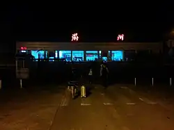 A lake separates the aircraft bays from the terminal building which is crossed by a long causeway