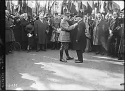 Michaux being presented the Legion of Honour. Michaux is dressed in dark colours and Foch in lighter colours