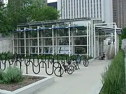 Rows of outdoor bike racks in a plaza in front of a building