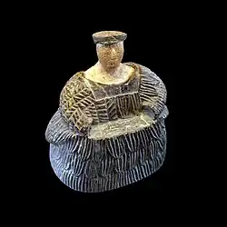 Female figurine of the "Bactrian princess" type; between 3rd millennium and 2nd millennium BC; chlorite mineral group (dress and headdresses) and limestone (face and neck); height: 17.3&nbsp;cm, width: 16.1&nbsp;cm; Louvre
