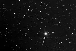 photograph of stars with an arrow pointing to one of them