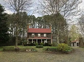 This is a picture of The Beadles House, a historic log cabin listed on the National Register of Historic Places.