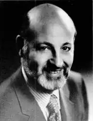 A black-and-white image of a middle-aged bald man