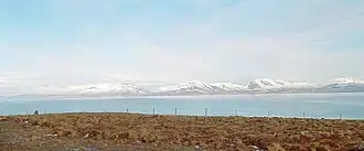 A view of the fjörd with snowy mountains on the far side