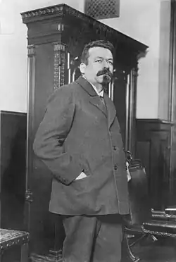 Black and white photograph of a standing man