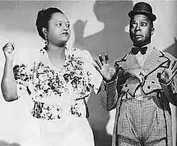 a woman holding up a fist ready to strike a frightened man