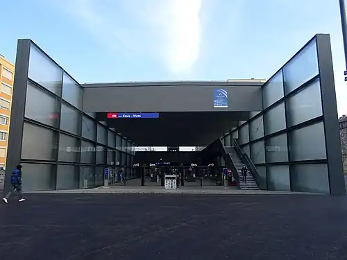 Square two-story glassed-in entrance to underground station