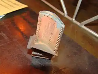 A used CFM56 high pressure turbine blade. New blades have 3 different-depth notches at the tip to aid visual assessment (using a borescope) of rubbed away material and consequent increase in tip clearance. 0.25&nbsp;mm of lost blade-tip causes a 10 deg C loss of EGT margin.[152]