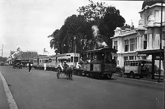 The steam tram in front of the Postspaarbank showing trams for three divided social classes.