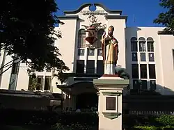 The school, with the statue of its Patron Saint, St. Augustine of Hippo
