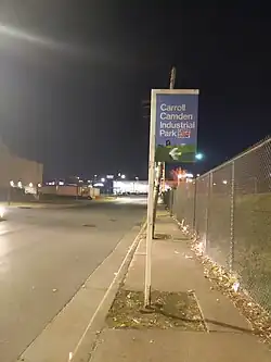 Guidepost sign pointing an entry to the Carroll-Camden Industrial Area from Russell Street in Baltimore