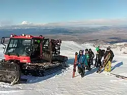 Skiers and snowboarders are dropped off at the Tukino ski field upper boundary by the cat skiing service.