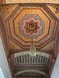Sculpted and painted wooden ceiling in one of the rooms around the courtyard