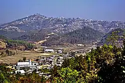 Champhai, Mizoram, from south, with Zotlang in the foreground. Taken from Ruantlang, across the Champhai Valley, with the town of Champhai stretched along the hill in the distance and the village of Zotlang in the foreground.
