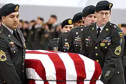 A casket team from the 1st Special Forces Group carry the flag-draped casket of Sergeant 1st Class Nathan R. Chapman on January 8, 2002, at Seattle-Tacoma International Airport.