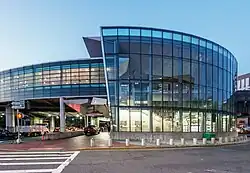A curved glass entrances building for an elevated railway station